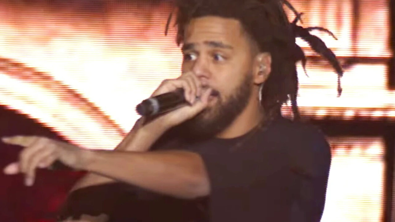 J. Cole 2026-2027 Tour & Schedule featuring J. Cole live on stage with stadium crowd