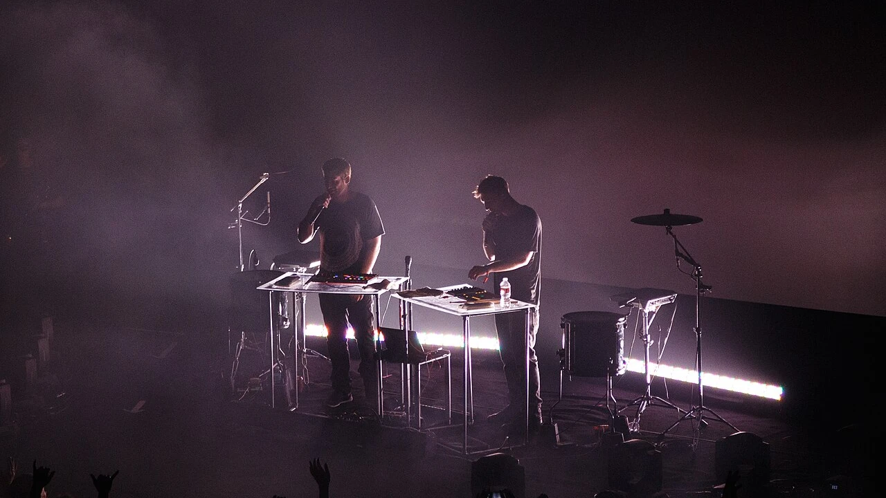 Odesza 2026-2027 Tour & Schedule featuring Odesza live on stage with stadium crowd
