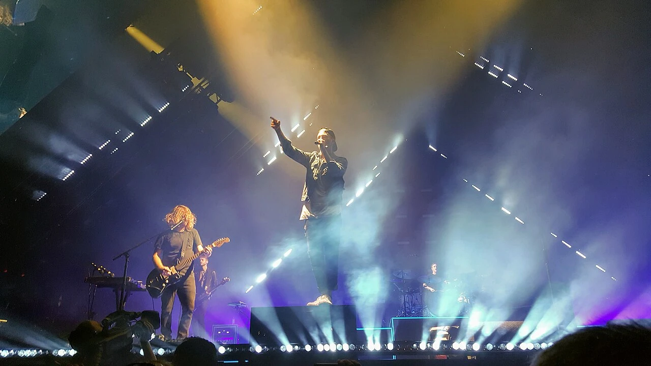 OneRepublic 2026-2027 Tour & Schedule featuring OneRepublic live on stage with stadium crowd